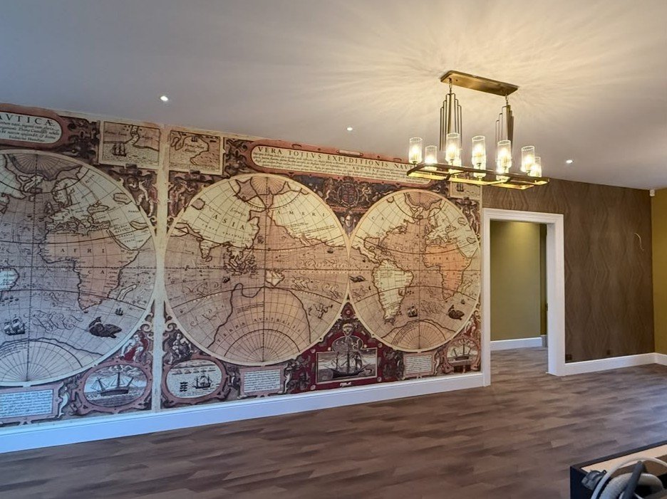 Antique world-map mural along a reception room wall, Mayfair Project — view 3