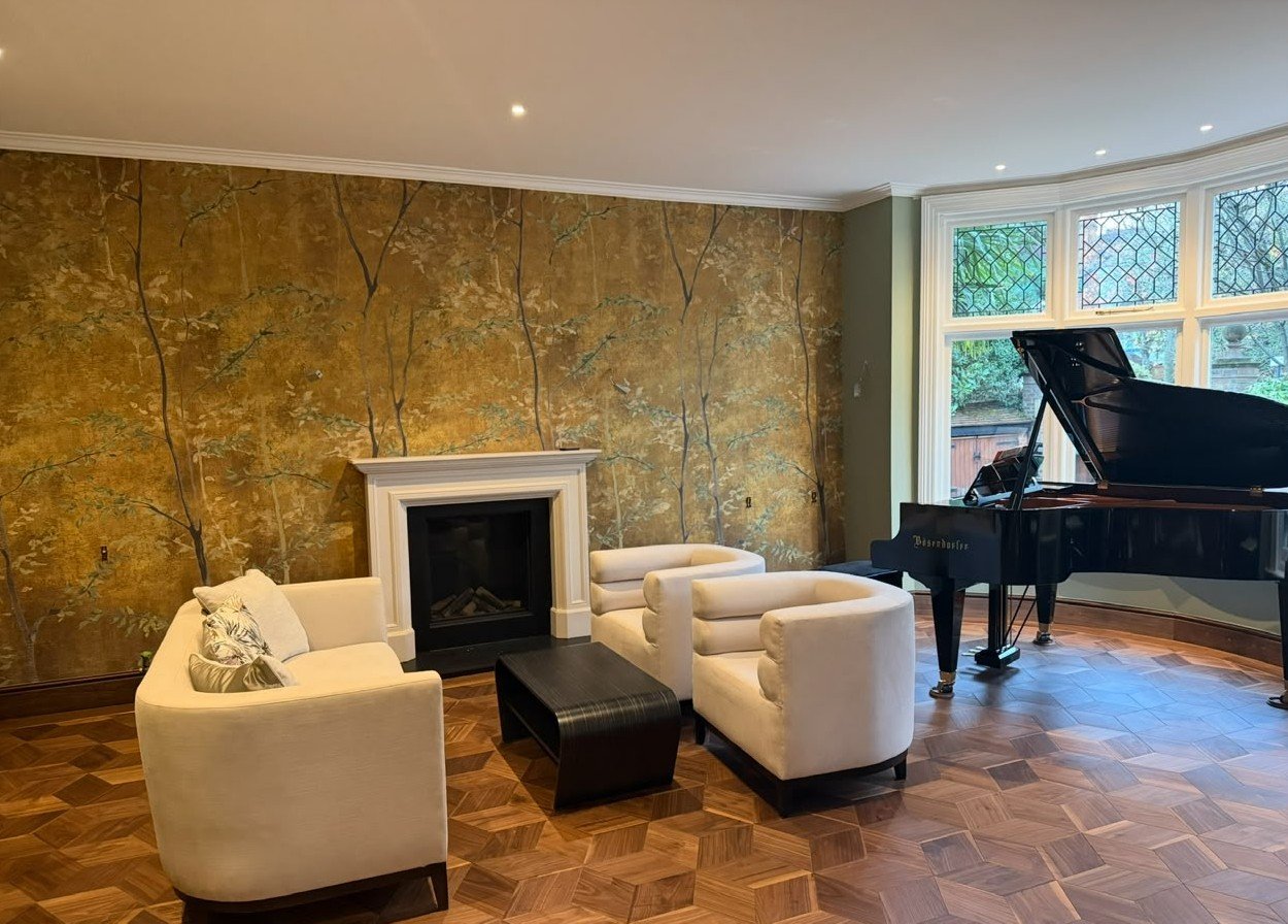 Sitting room wall papered with a gold woodland mural, Paddington Project — view 6